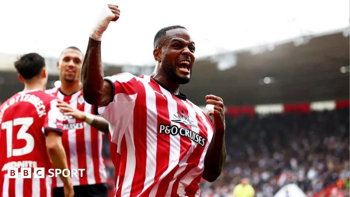 Player celebrating a goal with teammates at stadium Player celebrating a goal with teammates at stadium
