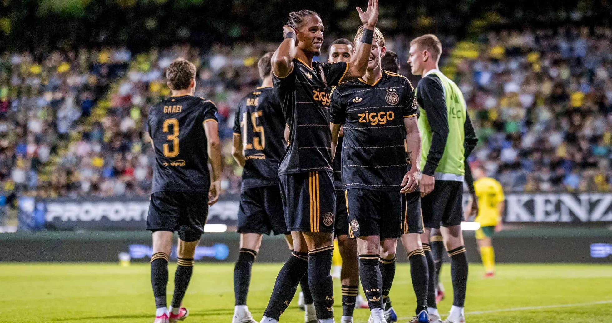 Ajax players celebrating a goal during a match Ajax players celebrating a goal during a match