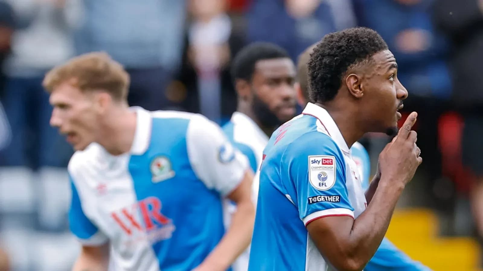 Player celebrating a goal with a shushing gesture Player celebrating a goal with a shushing gesture