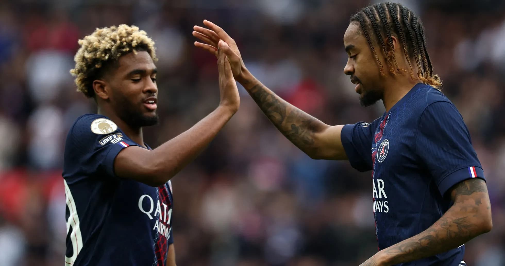 Two PSG players celebrating with a high-five Two PSG players celebrating with a high-five