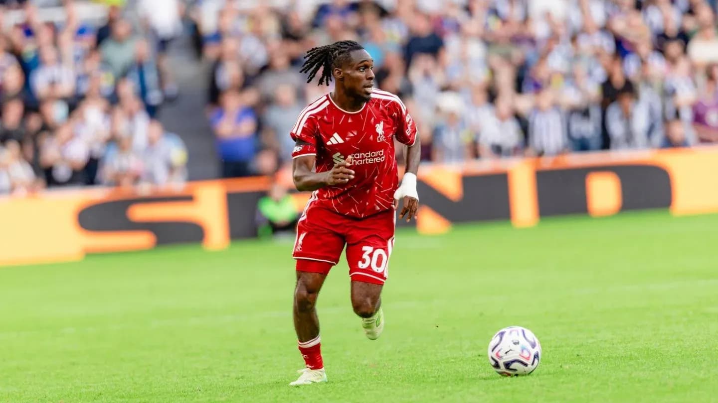 Player in red jersey running with soccer ball Player in red jersey running with soccer ball