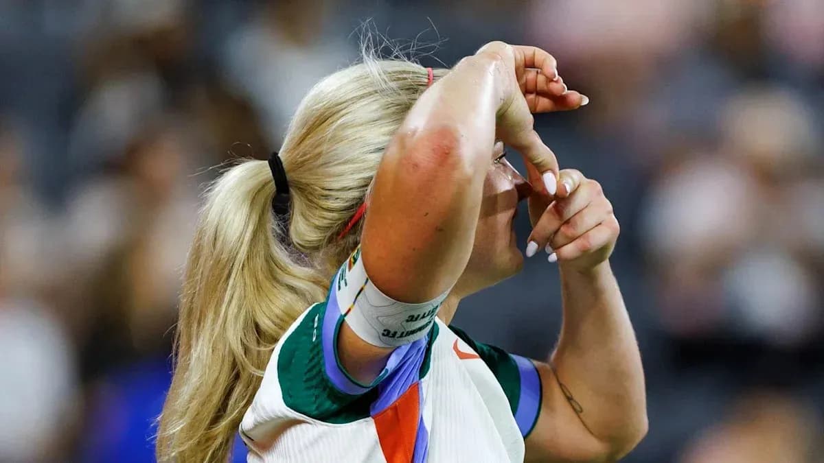 Athlete adjusting her visor during a match Athlete adjusting her visor during a match