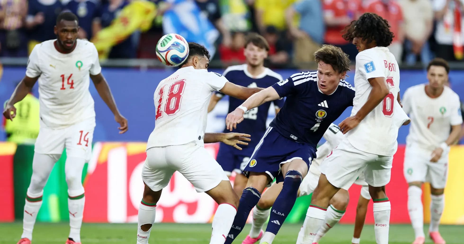 Players from Scotland and Morocco competing for the ball Players from Scotland and Morocco competing for the ball