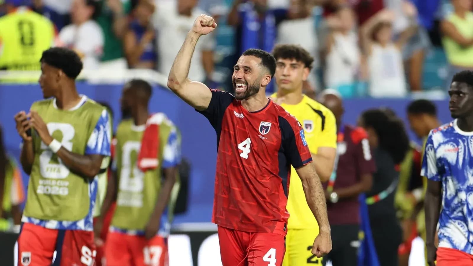 Player celebrating after match with teammates nearby Player celebrating after match with teammates nearby