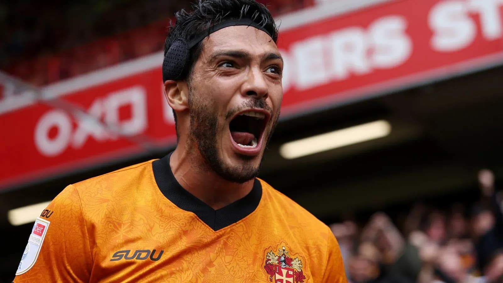 Player celebrating passionately in orange jersey Player celebrating passionately in orange jersey