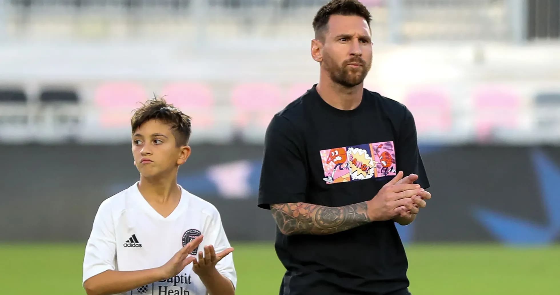 Lionel Messi and child applauding on the field Lionel Messi and child applauding on the field
