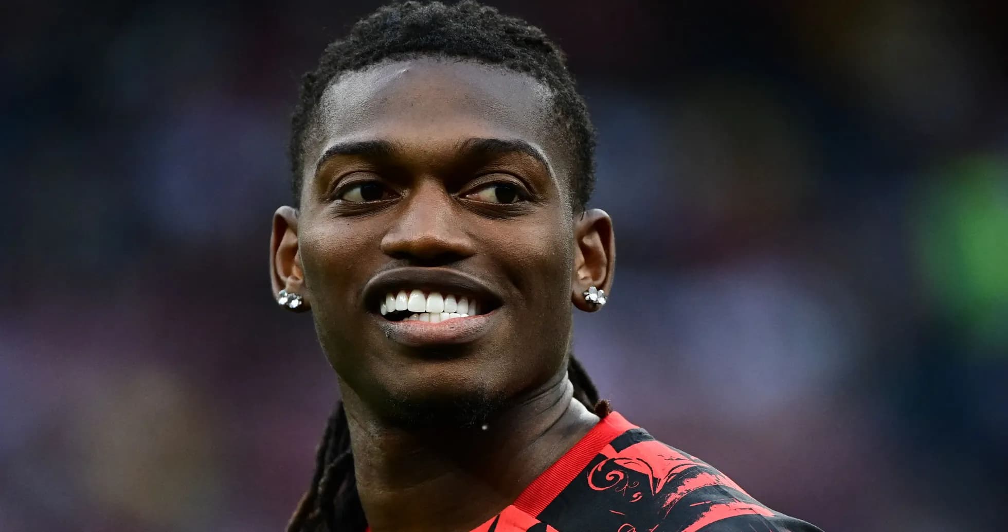 Player smiling in a red and black jersey Player smiling in a red and black jersey