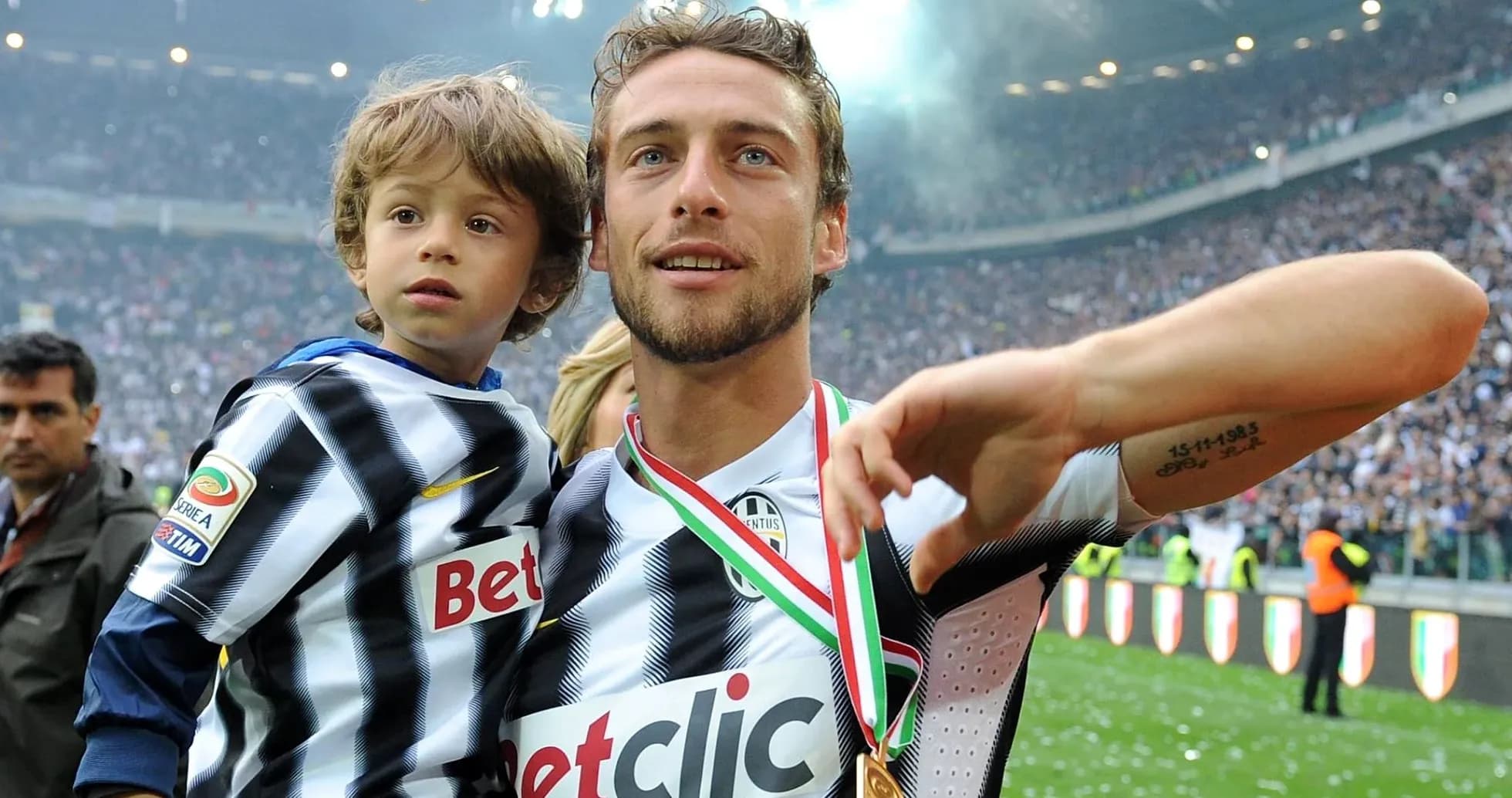 Player holding child while celebrating victory Player holding child while celebrating victory
