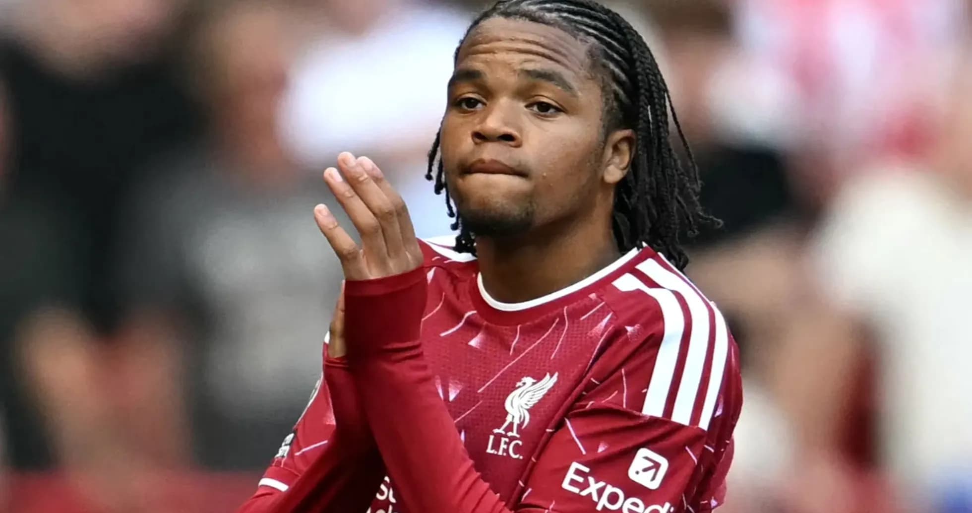 Player clapping while wearing Liverpool jersey Player clapping while wearing Liverpool jersey