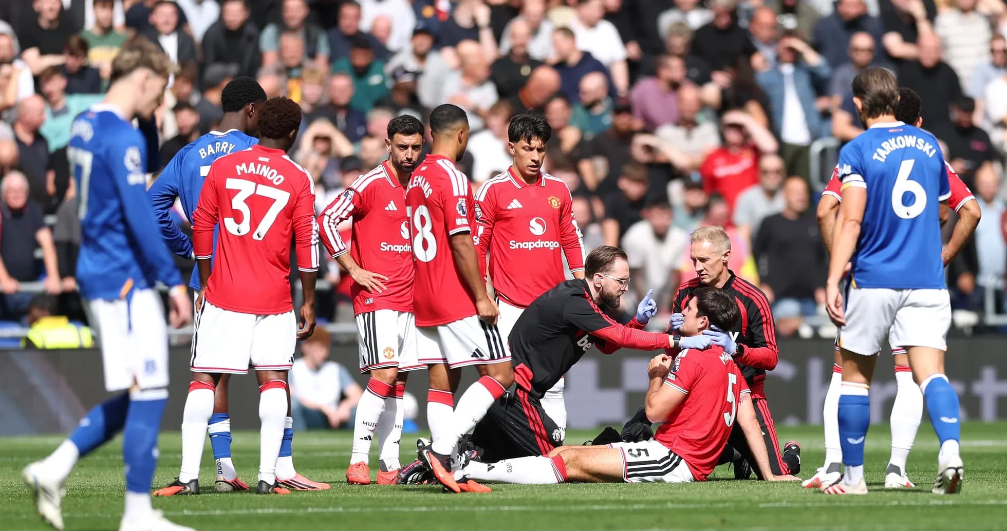 Players gathered around injured teammate on field Players gathered around injured teammate on field