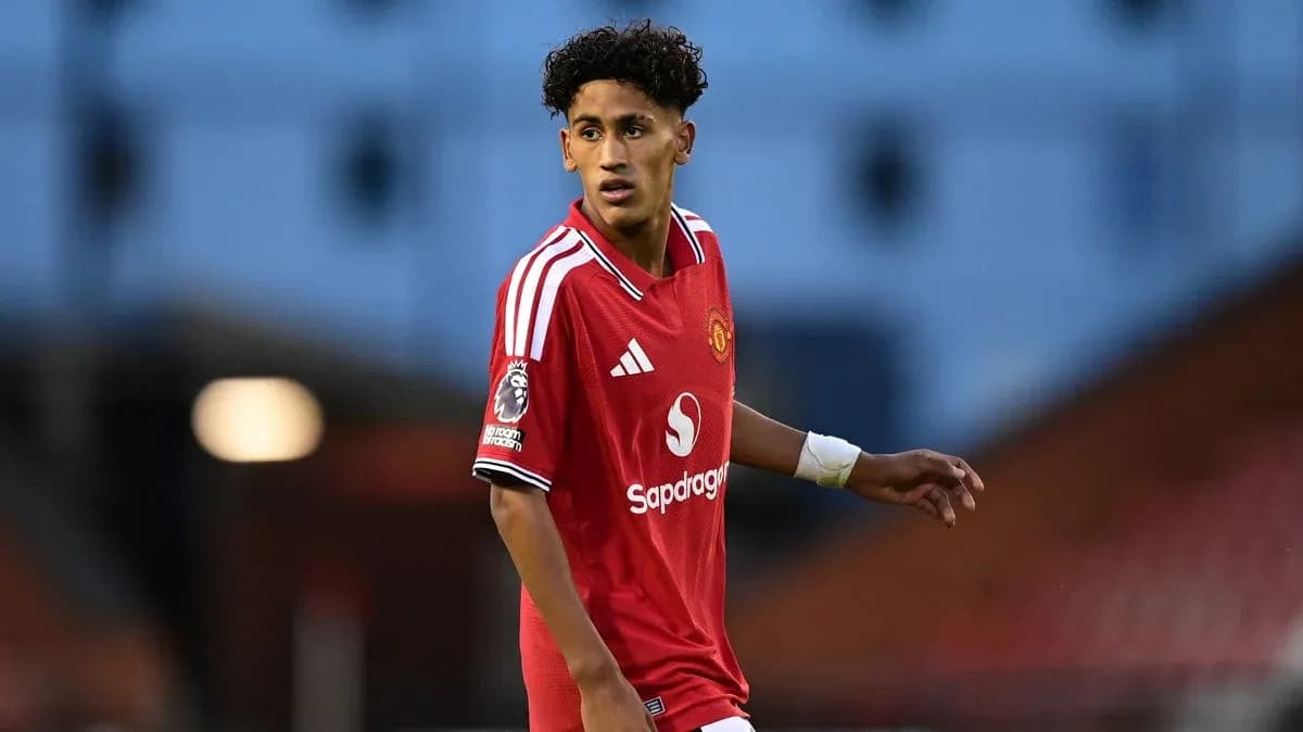 Player in red Manchester United kit on the field Player in red Manchester United kit on the field