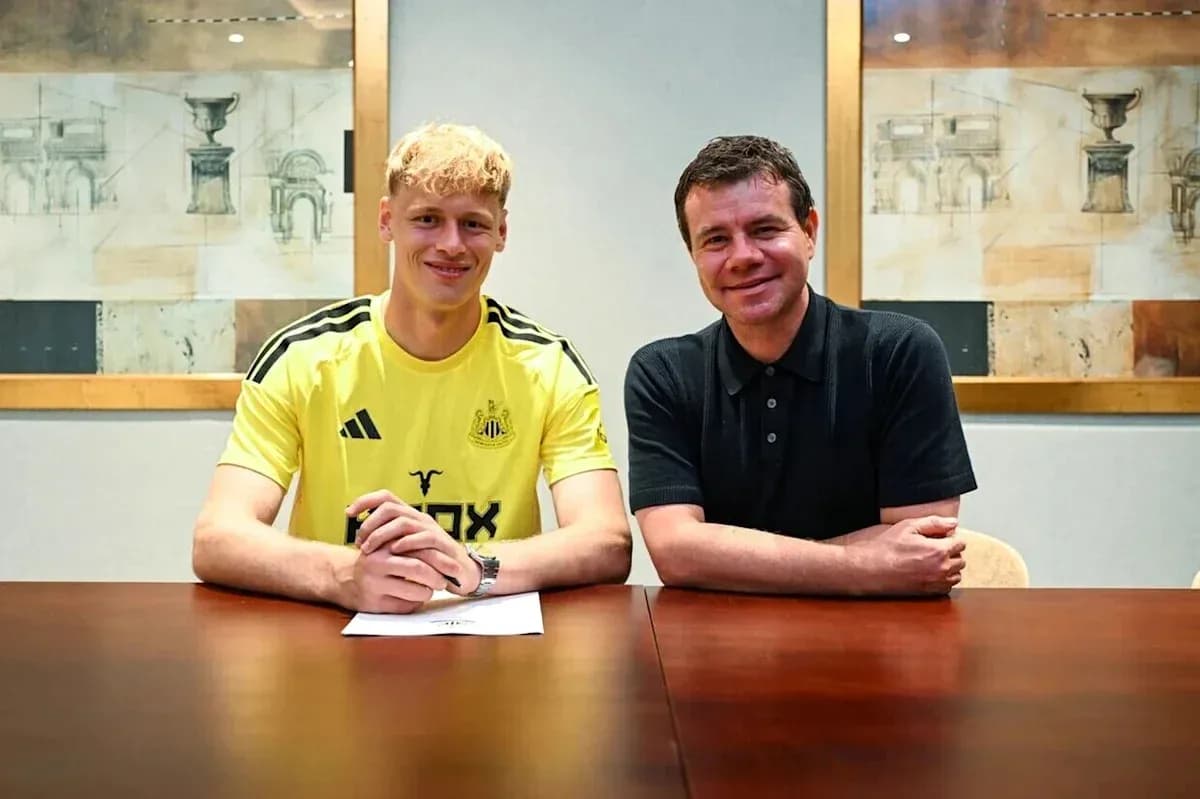 Player signing contract at club office with official Player signing contract at club office with official
