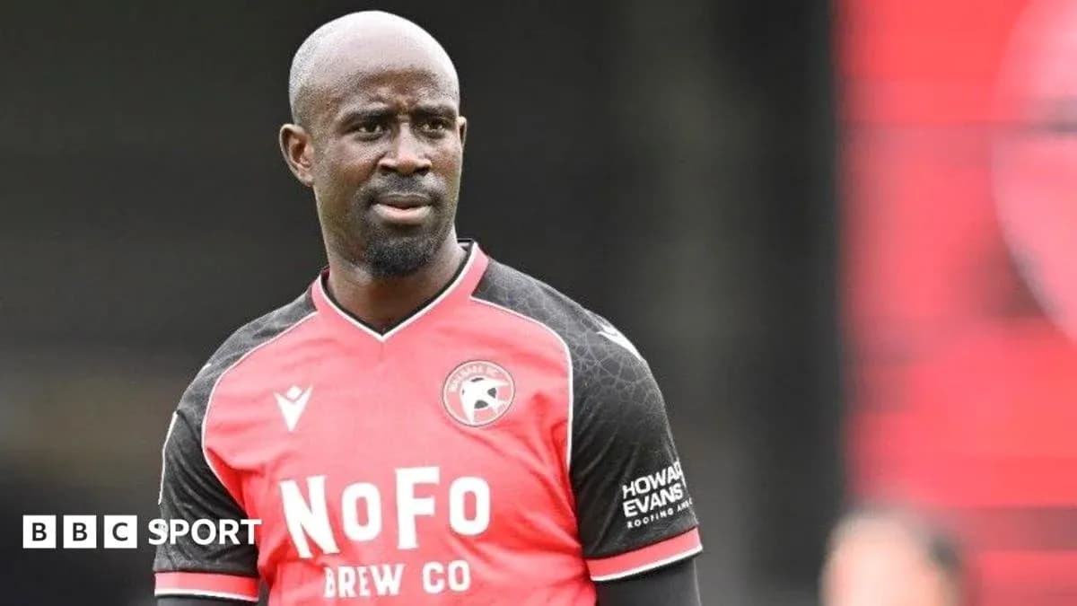 Player in red and black jersey during match Player in red and black jersey during match