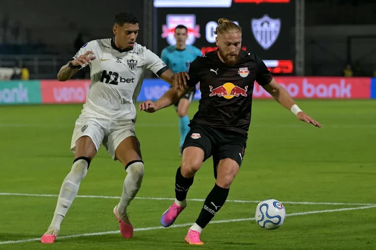 Two players competing for the ball in football match Two players competing for the ball in football match