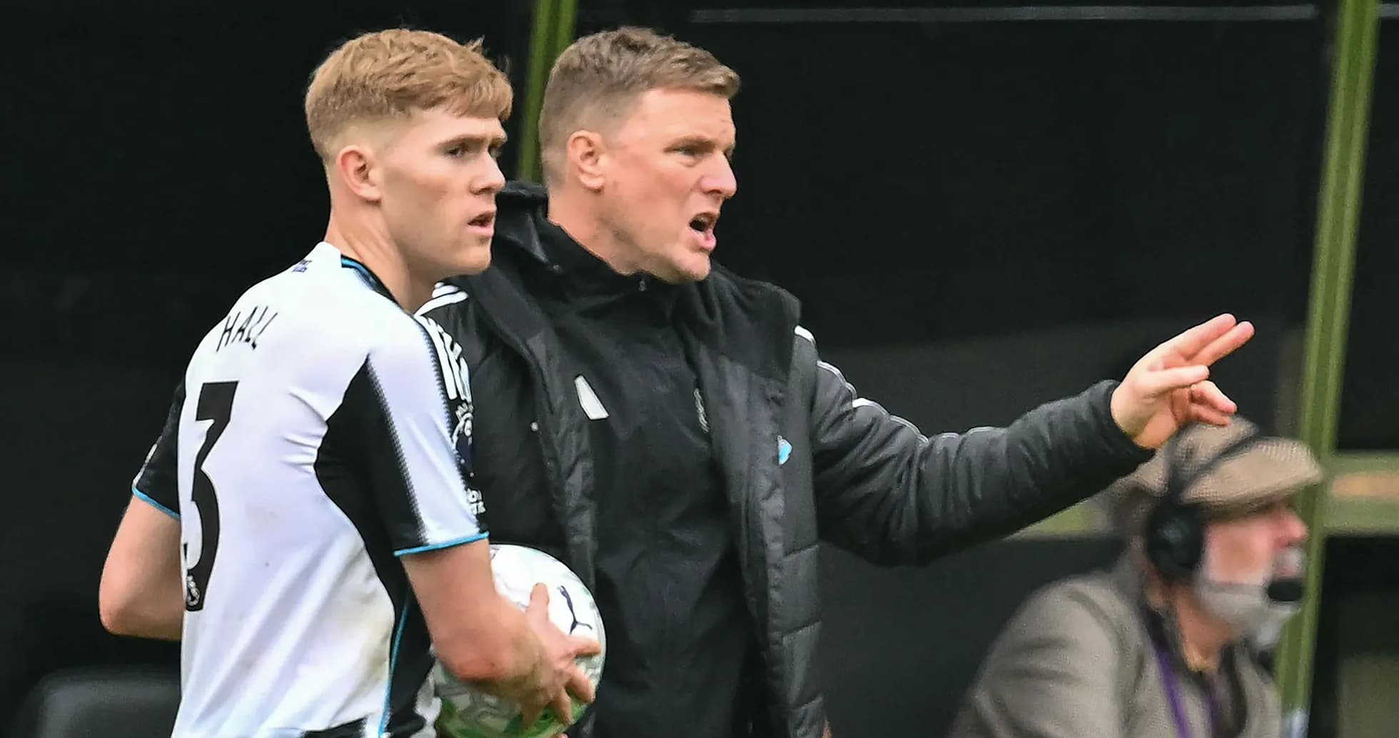Manager giving instructions to player on sidelines Manager giving instructions to player on sidelines