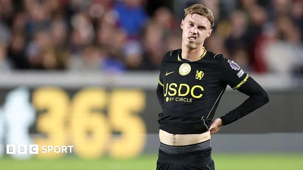 Player in black jersey showing frustration on field Player in black jersey showing frustration on field