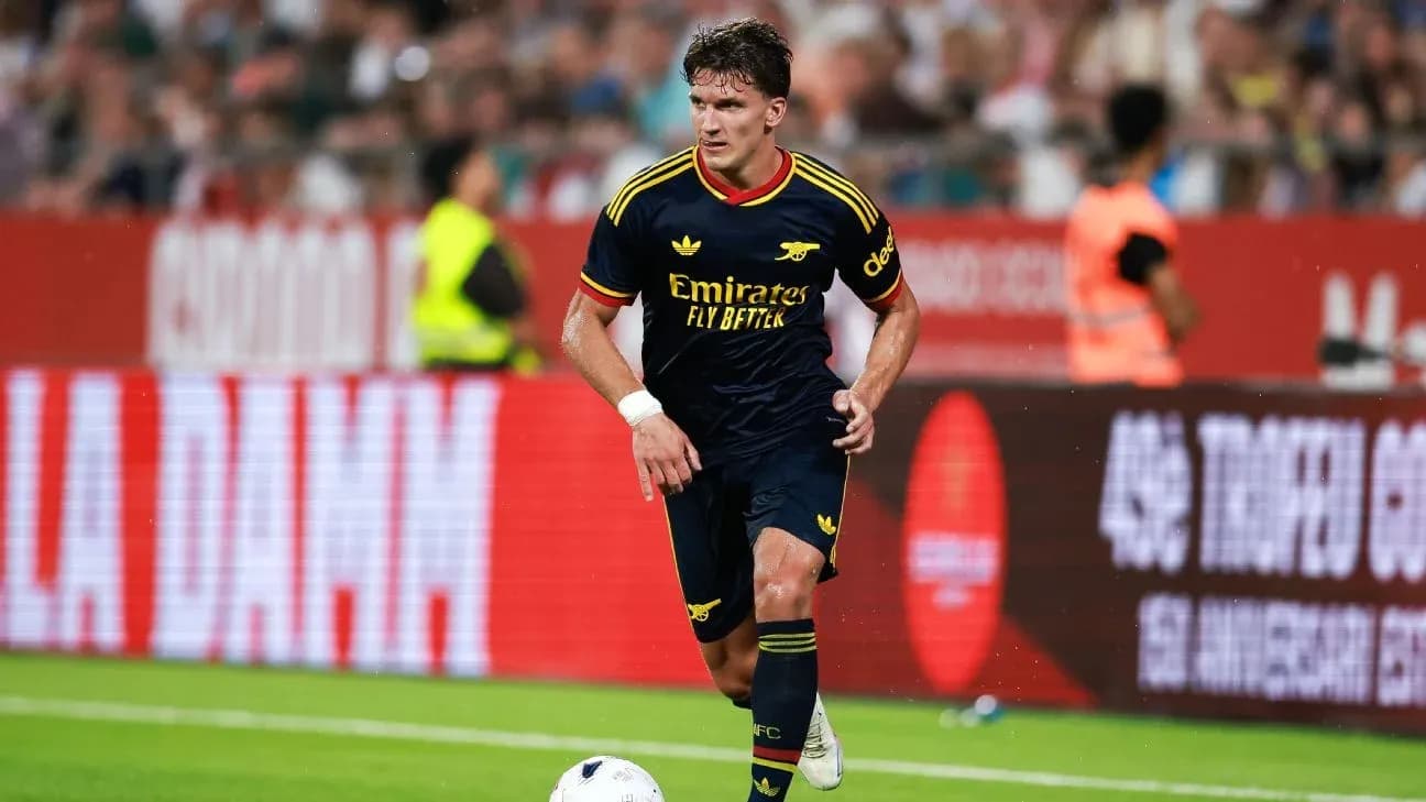 Player dribbling ball during match in Arsenal kit Player dribbling ball during match in Arsenal kit