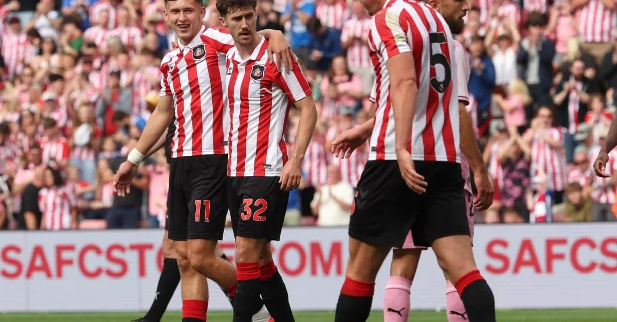 Sunderland players celebrating a goal together on pitch Sunderland players celebrating a goal together on pitch