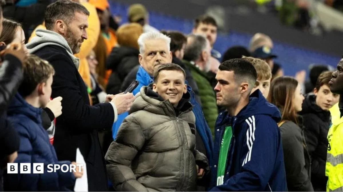 Fans interacting near the sidelines after a match Fans interacting near the sidelines after a match