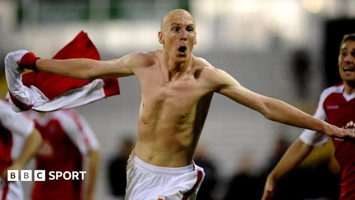Player celebrating with shirt after scoring a goal Player celebrating with shirt after scoring a goal
