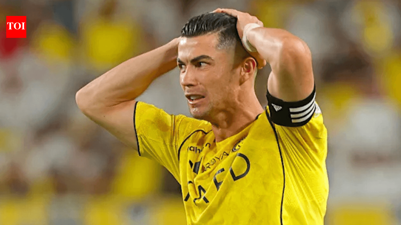 Player in yellow jersey holding head in frustration Player in yellow jersey holding head in frustration
