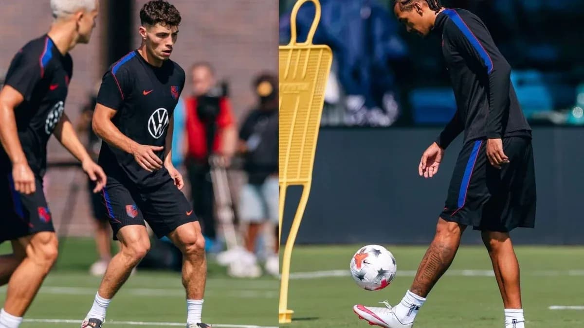 Two players training on the pitch with a soccer ball Two players training on the pitch with a soccer ball