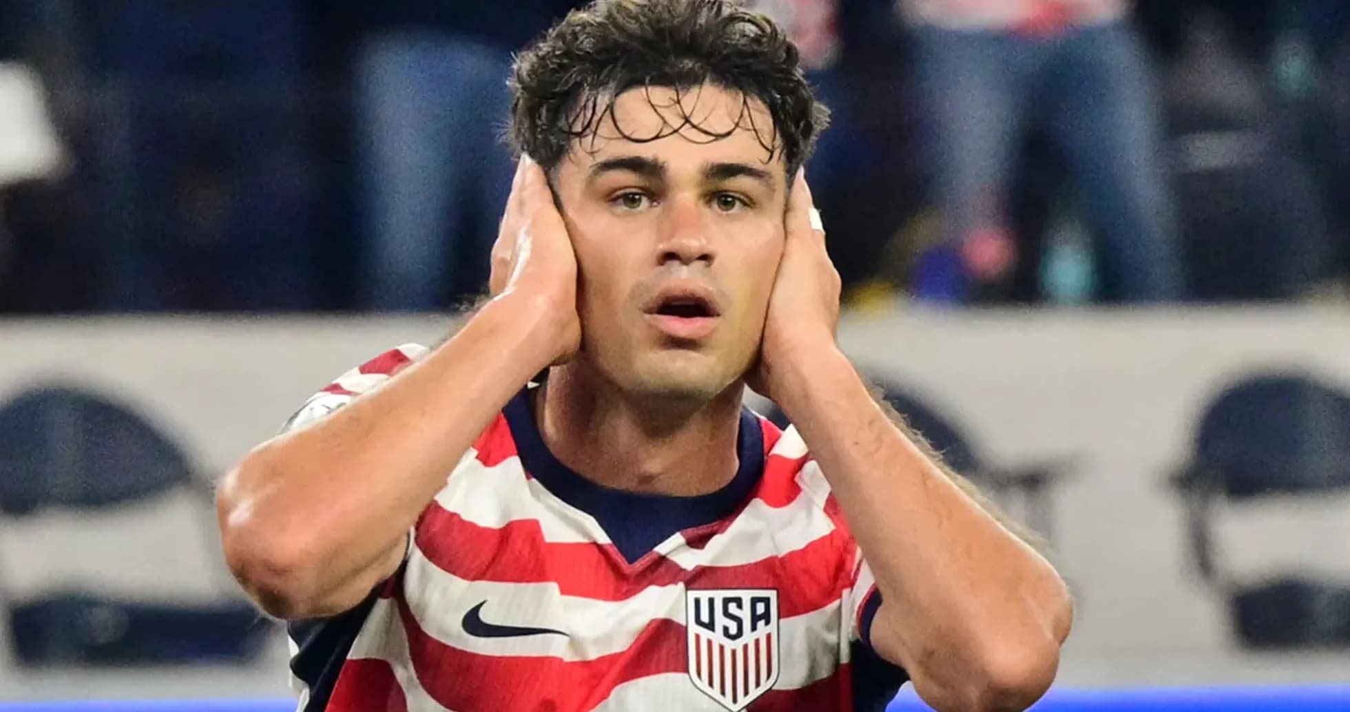 Player covering ears during a soccer match Player covering ears during a soccer match
