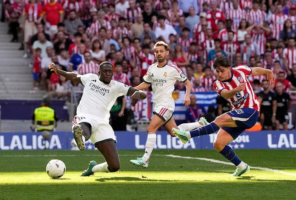 Atletico Madrid player shooting during derby match Atletico Madrid player shooting during derby match