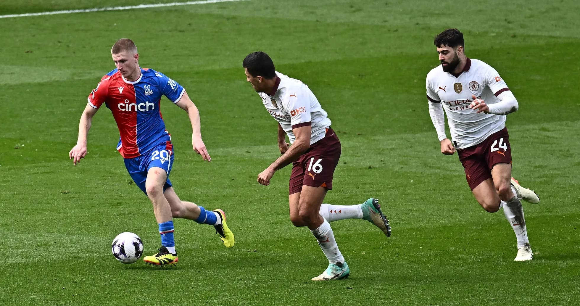 Player dribbling the ball pursued by two defenders Player dribbling the ball pursued by two defenders