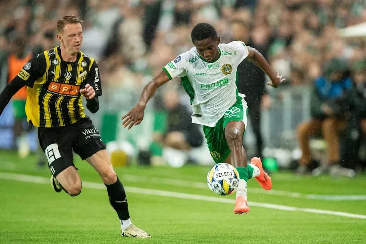 Player in green dribbling past opponent in yellow Player in green dribbling past opponent in yellow