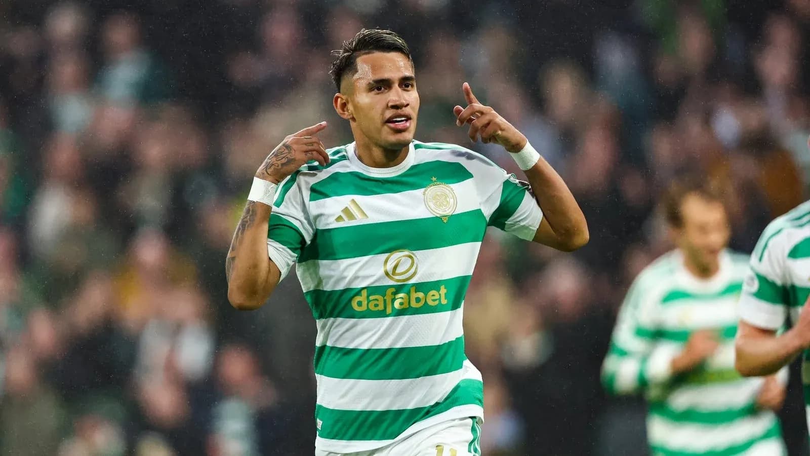 Player celebrating goal wearing Celtic FC jersey Player celebrating goal wearing Celtic FC jersey