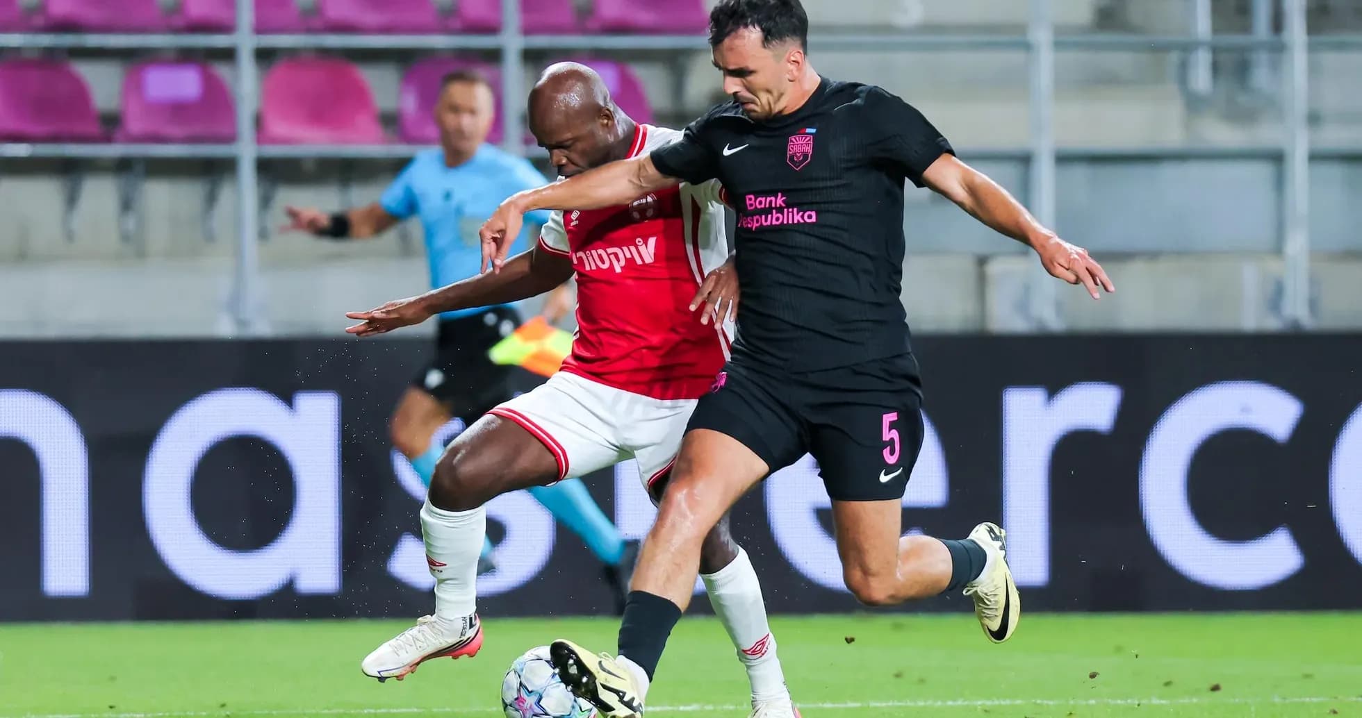 Two players competing for the ball in match Two players competing for the ball in match