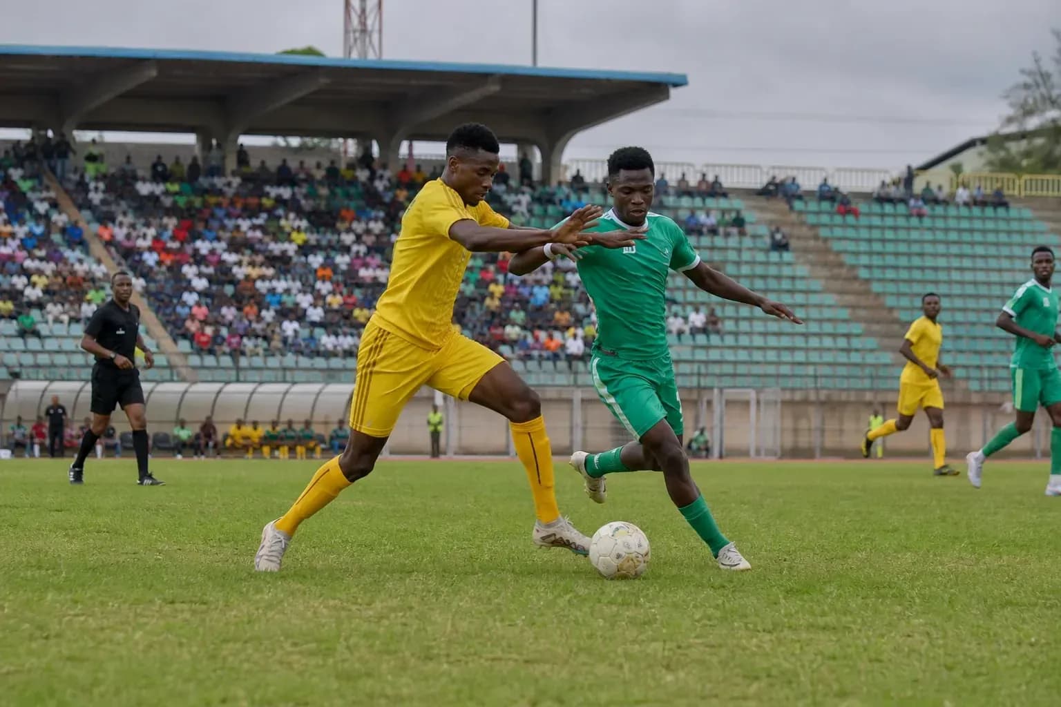 Players competing for the ball during CAF match Players competing for the ball during CAF match