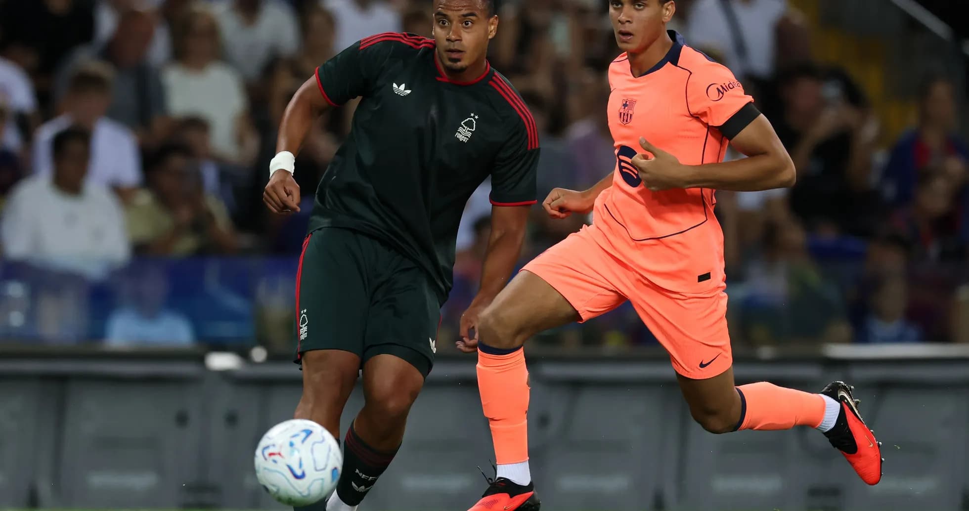 Two players competing for the ball during a match Two players competing for the ball during a match