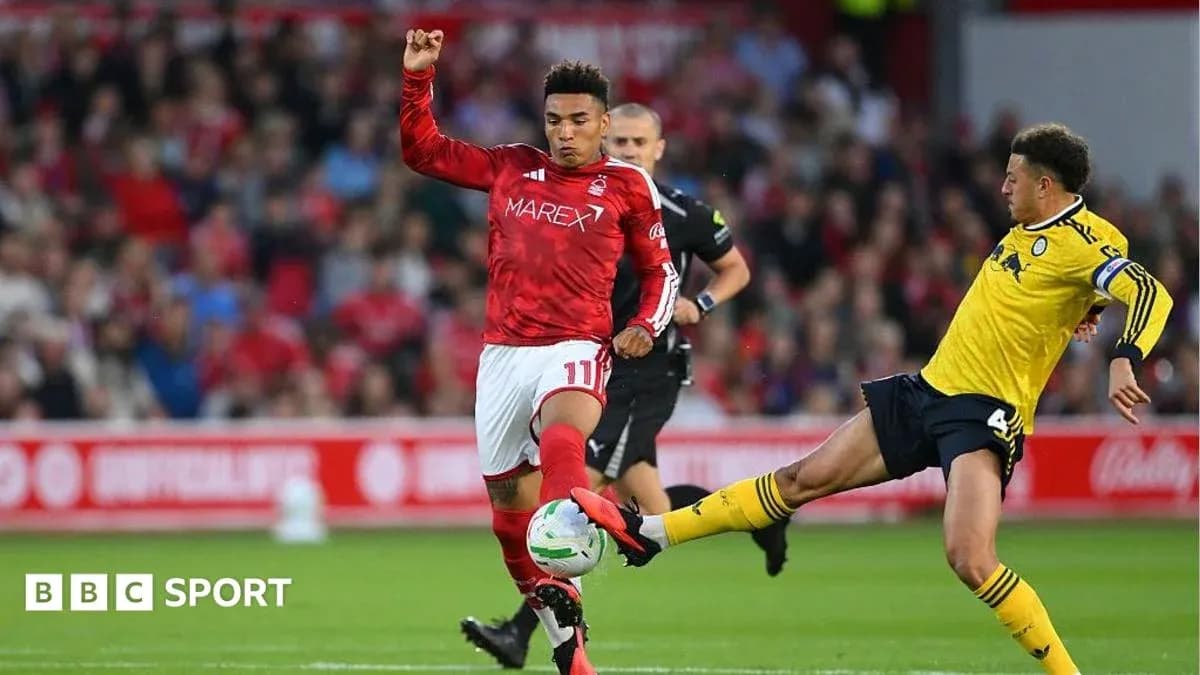 Player in red evading a tackle during match Player in red evading a tackle during match