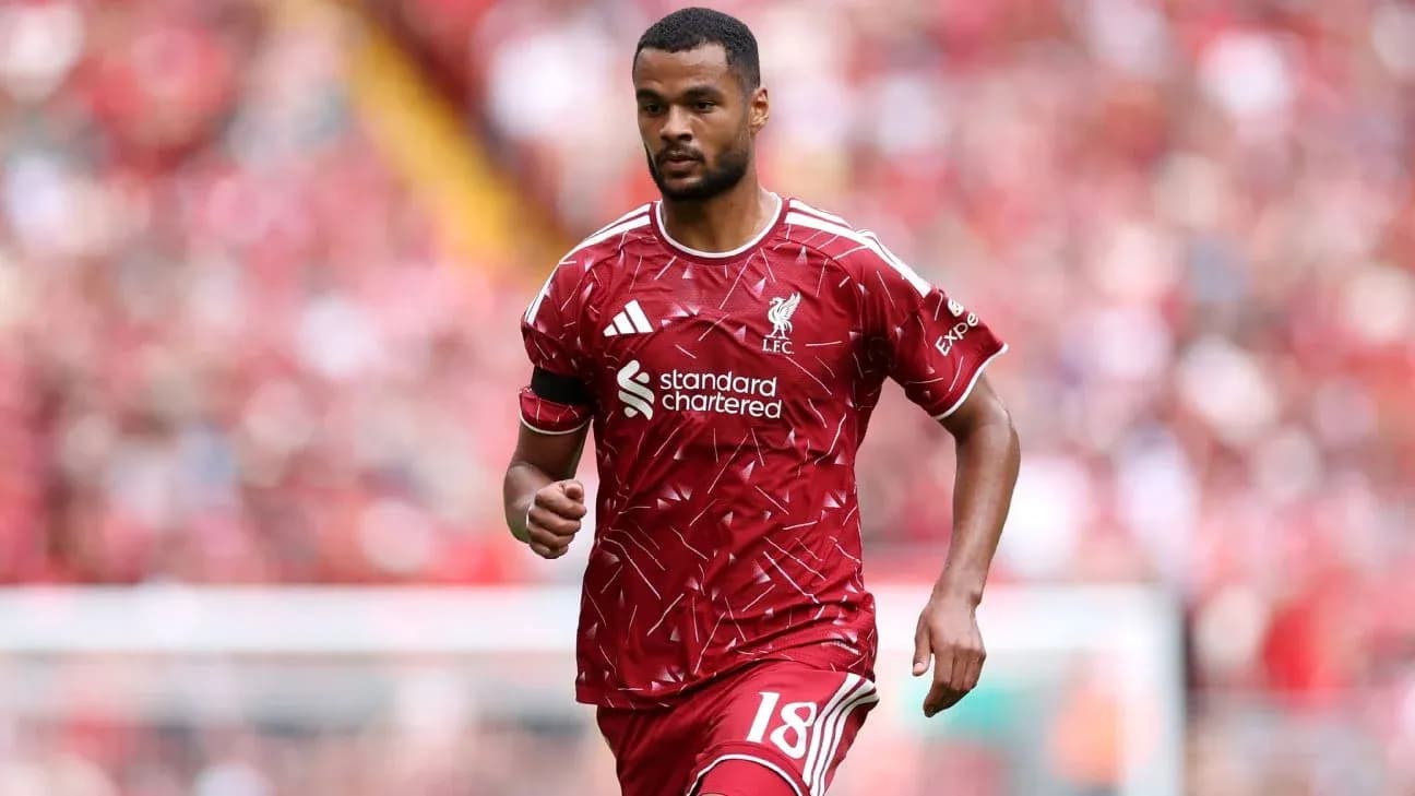 Player in Liverpool kit running on the pitch Player in Liverpool kit running on the pitch