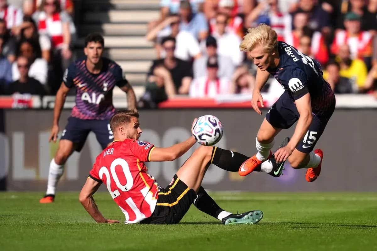 Player tackling another during a football match Player tackling another during a football match