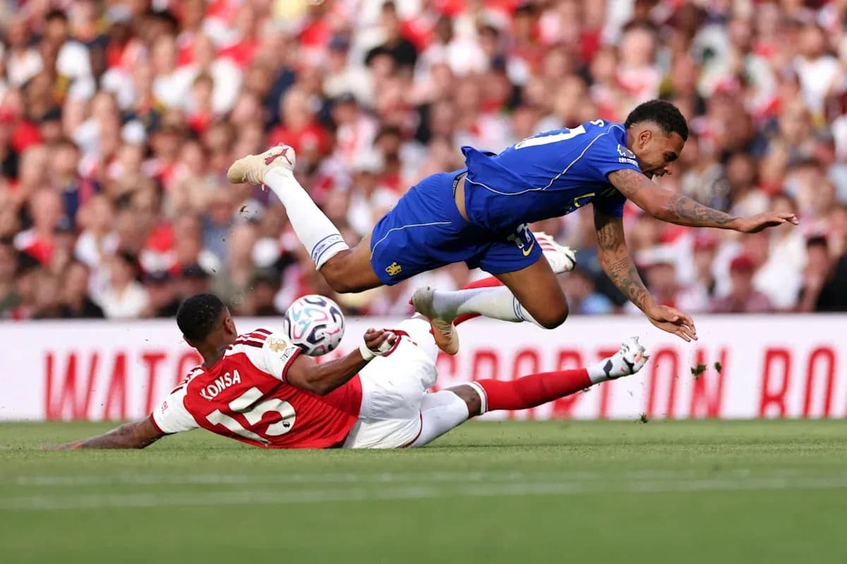 Player falling over another during a football match Player falling over another during a football match