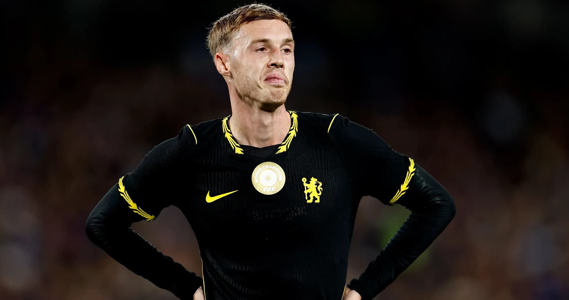 Player in black kit with yellow accents, looking concerned Player in black kit with yellow accents, looking concerned