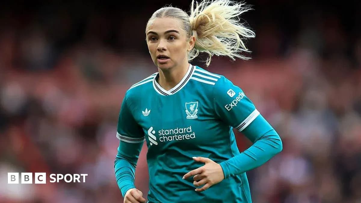 Female player running in Liverpool kit during match Female player running in Liverpool kit during match