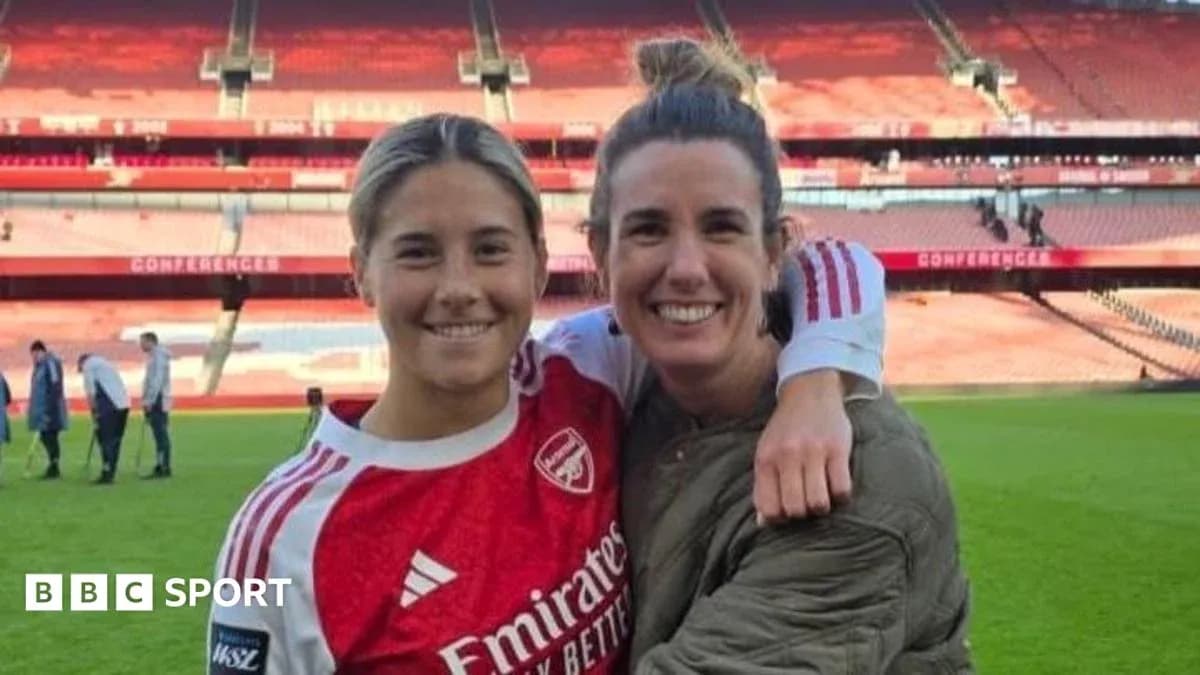 Two female football players posing at stadium Two female football players posing at stadium