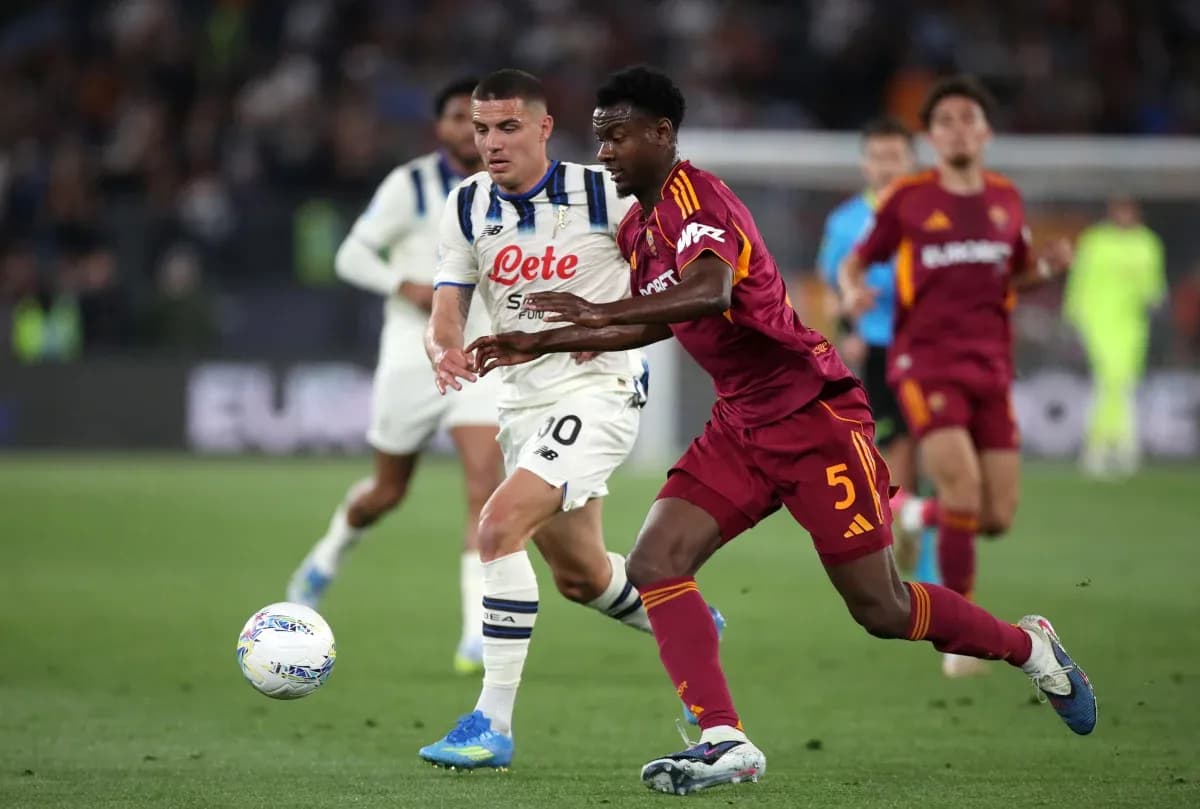 AS Roma player tackling Atalanta opponent AS Roma player tackling Atalanta opponent
