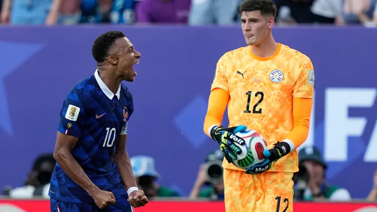 French player celebrating next to Paraguayan goalkeeper French player celebrating next to Paraguayan goalkeeper