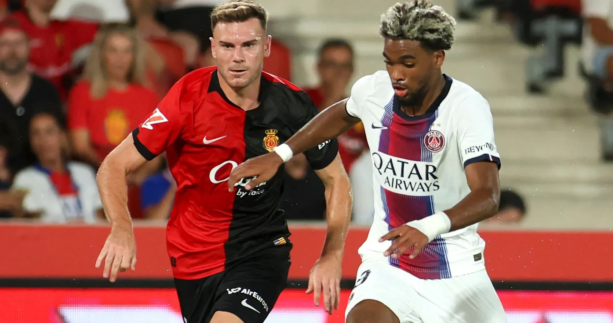 Player from PSG dribbling past Mallorca defender Player from PSG dribbling past Mallorca defender