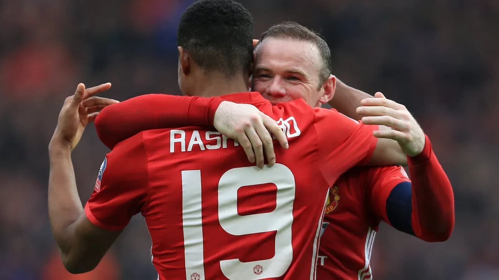 Players celebrating a goal in Manchester United jerseys Players celebrating a goal in Manchester United jerseys