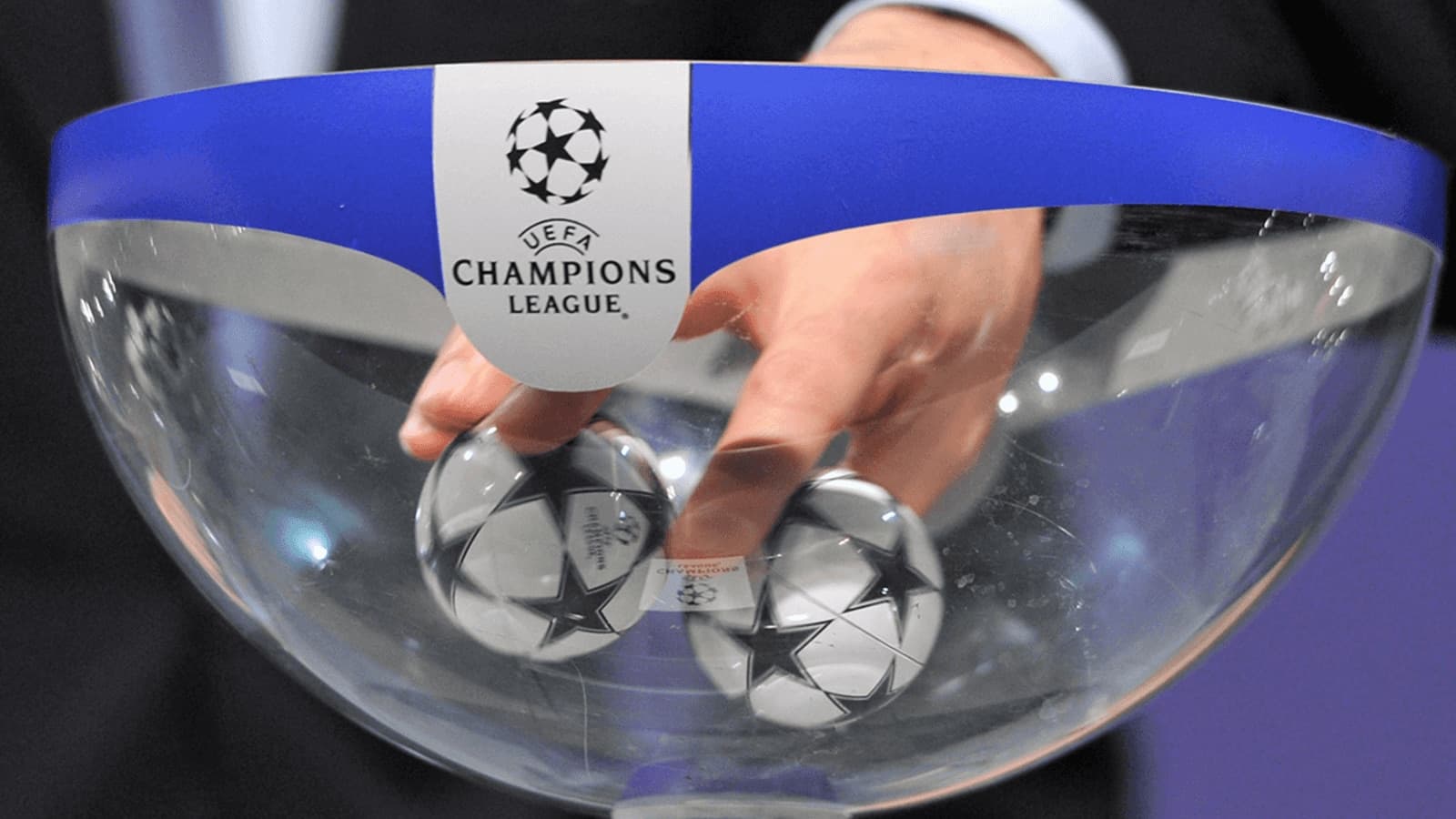 Hand reaching into bowl for Champions League draw Hand reaching into bowl for Champions League draw