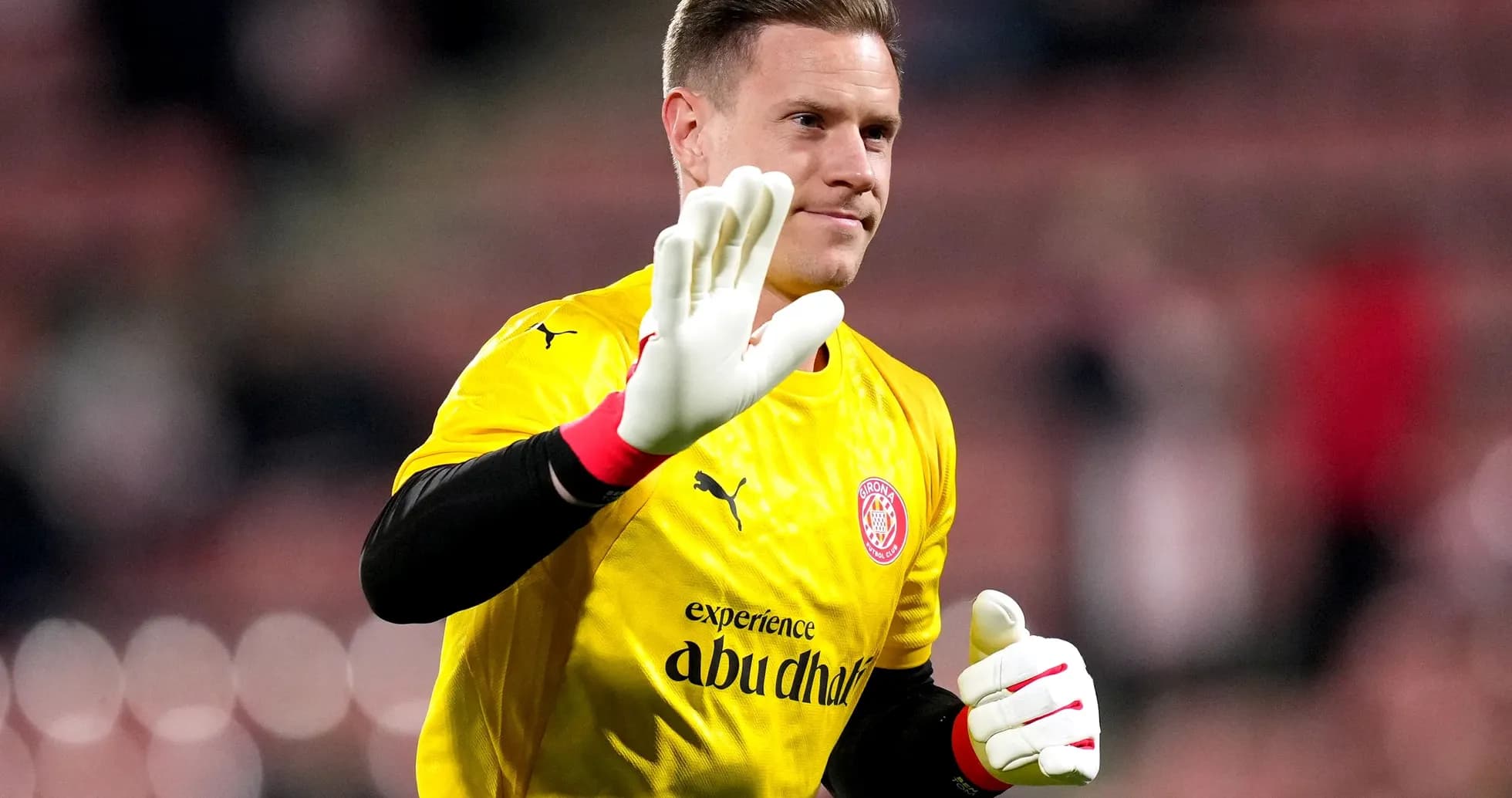 Goalkeeper in yellow kit waving to the crowd Goalkeeper in yellow kit waving to the crowd