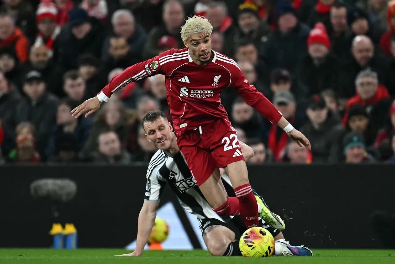 Liverpool player fouled by Newcastle opponent Liverpool player fouled by Newcastle opponent