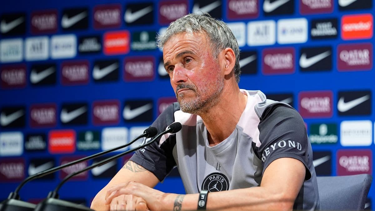 Manager speaking at press conference with logos behind Manager speaking at press conference with logos behind