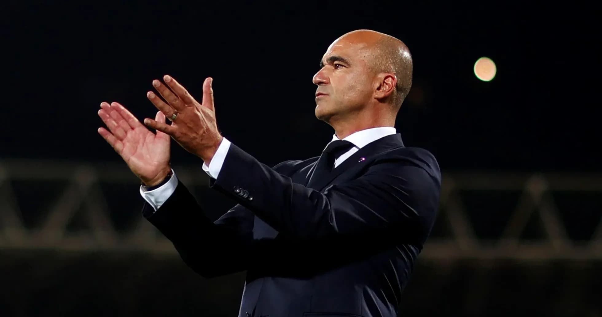 Manager applauding during a match on the sideline Manager applauding during a match on the sideline